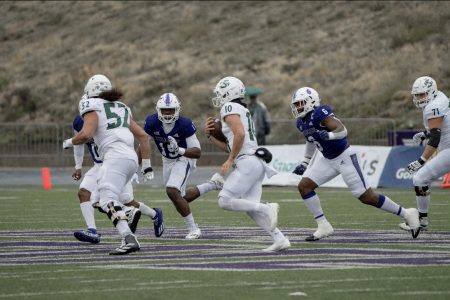 Senior quarterback Asher O’Hara sprints down the field with his blockers against Weber State, Saturday, Nov. 5, 2022 at Stewart Stadium in Ogden, Utah. O’Hara scored two touchdowns, bringing his season total to 16 scores.
