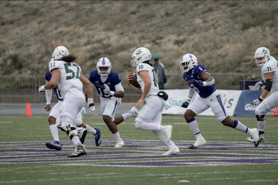 Senior+quarterback+Asher+O%E2%80%99Hara+sprints+down+the+field+with+his+blockers+against+Weber+State%2C+Saturday%2C+Nov.+5%2C+2022+at+Stewart+Stadium+in+Ogden%2C+Utah.+O%E2%80%99Hara+scored+two+touchdowns%2C+bringing+his+season+total+to+16+scores.