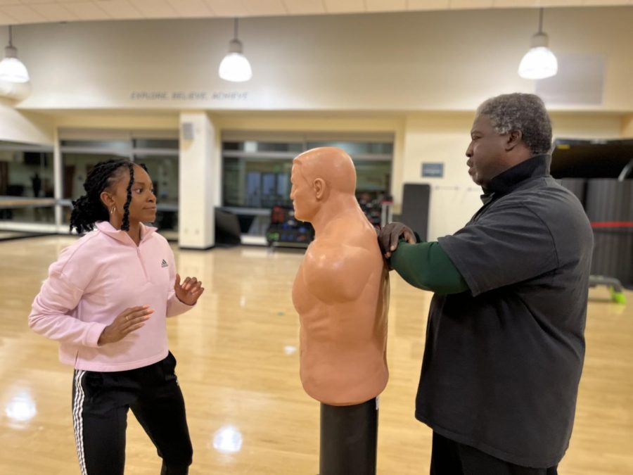 (L-R) Alexandra Boyd practices the moves she learned during the self defense class at The WELL while Vic Vinson watches on Nov. 14, 2022. Boyd said she finally decided to sign up for the self-defense class after the recent surge of sexual assault cases at Sac State.