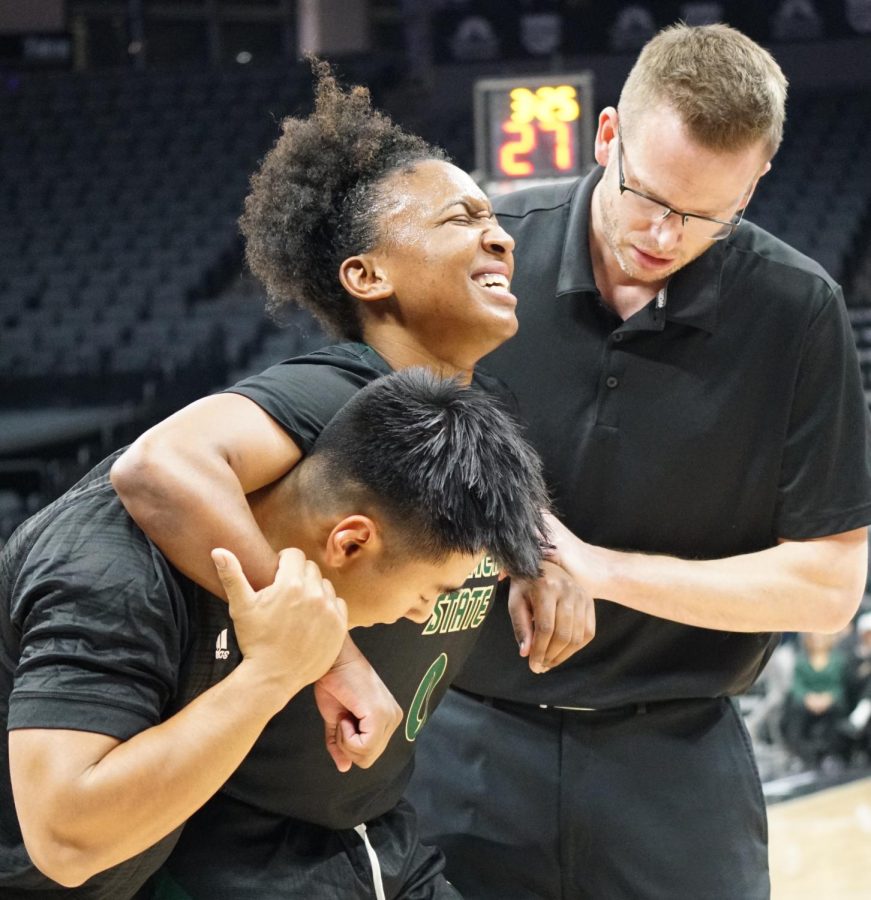Sac State head coach Mark Campbell helps senior guard Kahlaijah Dean off the court after an injury suffered in the second quarter of the Hornets 67-45 win over UC Davis at Golden 1 Center Tuesday, Nov. 22, 2022. Dean was able to return in the second half and got her first double-double as a Hornet.
