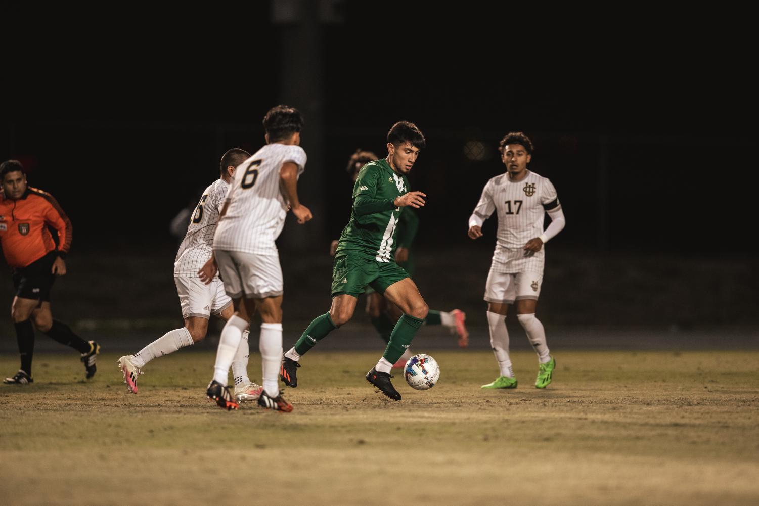 Sac State junior midfielder Francisco Magaña dribbles between UC Irvine defenders on Wednesday, Nov. 2, 2022, at Bren Events Center. The Hornets were shutout for the fourth time this season– twice versus the Anteaters. 

