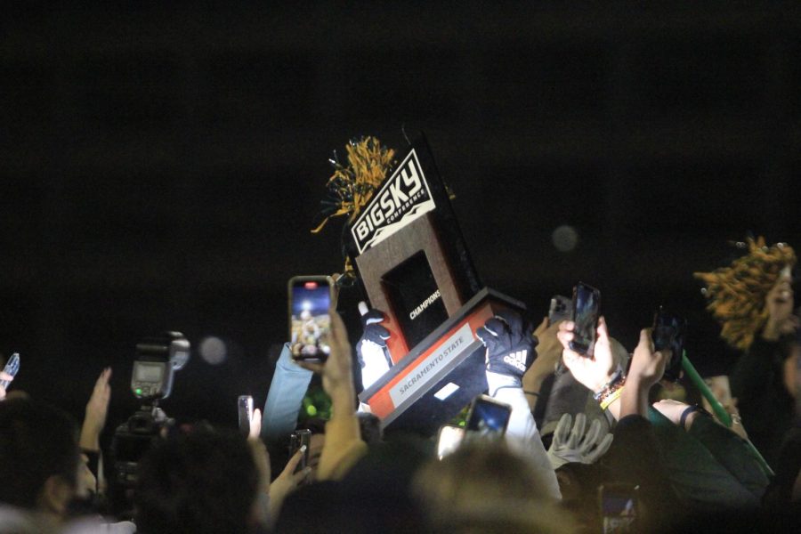 Sac State football and fans holding up the Big Sky Conference trophy in celebration of the Hornets clinching a share of the title after a 27-21 win against UC Davis Saturday, Nov.19, 2022, at Hornet Field. The Hornets also clinched home-field advantage throughout the 2202 FCS playoffs with the defeat of the Aggies.