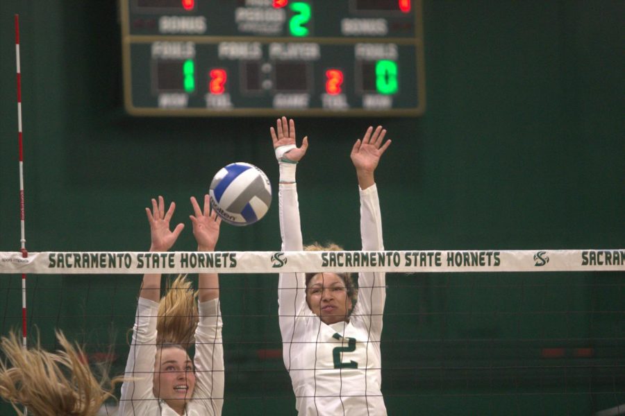 (FILE) Sac State junior middle blocker Kalani Hayes and junior outside hitter Caitlin Volkmann attempting to double block a ball at the net Saturday, Nov. 12, 2022, against Idaho at The Nest. The Hornets ended their season with an even record of 15-15.