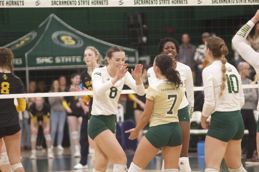 Sac State volleyball players celebrate immediately after scoring against Idaho on Saturday, Nov. 12, 2022, at The Nest. The Hornets are now 10-5 in the Big Sky conference play after winning 3-1 against the Vandals. 
