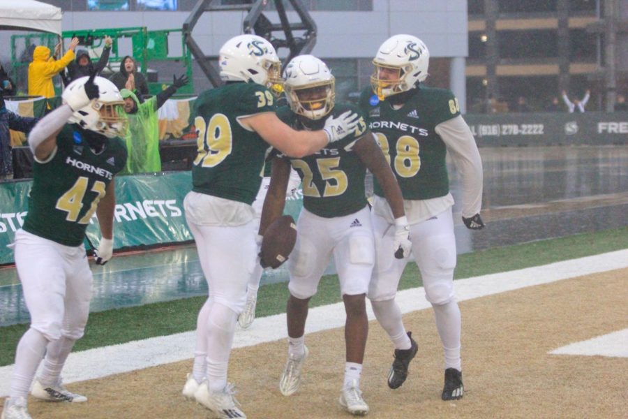 Freshman linebacker Oge Feo, junior linebacker Jeremy Harris and junior tight end Charlie McBride congratulate redshirt freshman running back Eljiah Tau-Tolliver after his 95-yard kick return touchdown Saturday, Dec. 3, 2022, at Hornet Stadium. Tau-Tolliver’s return was instrumental in the Hornets comeback for their first FCS playoff win in school history.

