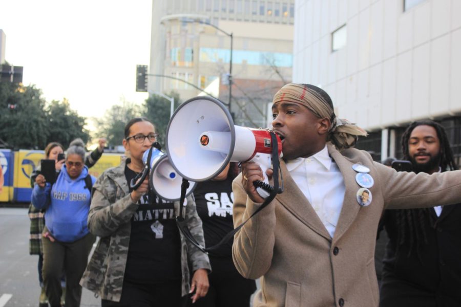 Stevante Clark speaking to a crowd of protesters as they march through the streets of downtown Sacramento Friday, Jan. 27, 2023. The protest was prompted following the release of body camera footage showing 29-year-old Tyre Nichols being beaten by Memphis police officers. Nichols died days later. (Photo by Alyssa Branum) 