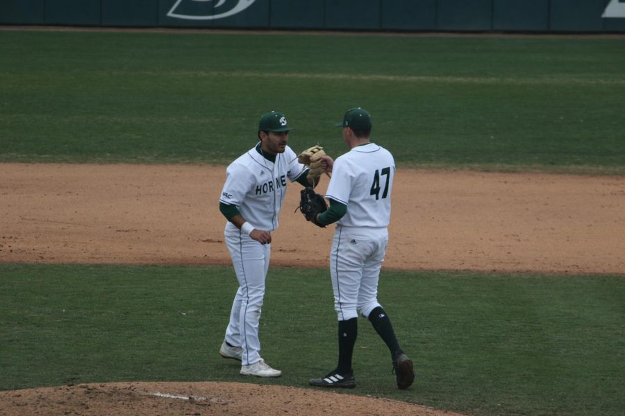 (R-L) Senior closer Jack Zalasky and junior third baseman Jorge Bojorquez talk at the beginning of the ninth inning of the first game of a doubleheader at John Smith Field Saturday, Feb. 25, 2023. Zalasky leads the team in saves with three.