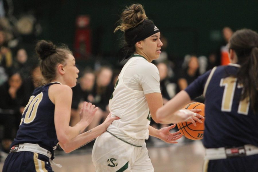 Senior guard Jordan Oliveras hands the ball to a teammate around Montana State defenders at The Nest during Sac State’s record-breaking win Thursday, Feb. 23, 2023. Oliveras has appeared in 93 games over her Sac State career.