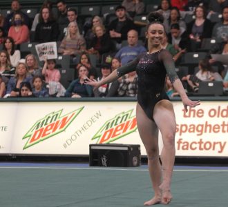 Senior Amber Koeth performs her final floor routine with a smile on her face at The Nest on senior night Friday, March 3, 2023. Koeth’s routine tied two school records, scoring 9.950 in both her beam and floor routine. 