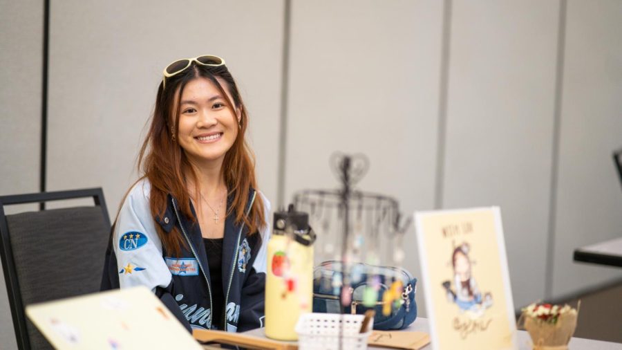Fourth-year child development major Mimi Nguyen sat at her booth at the Forces of Nature fashion show Sunday, April 23, 2023. Nguyen offers an assortment of handmade jewelry through her shop With Luv By Mi.