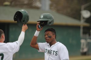 [FILE]Sophomore outfielder Jeffery Heard celebrates a run scored with a teammate at John Smith Field Saturday, March 18, 2023. Heard hit his third home run of the year in Saturday’s 15-13 loss to Stephen F. Austin State. 