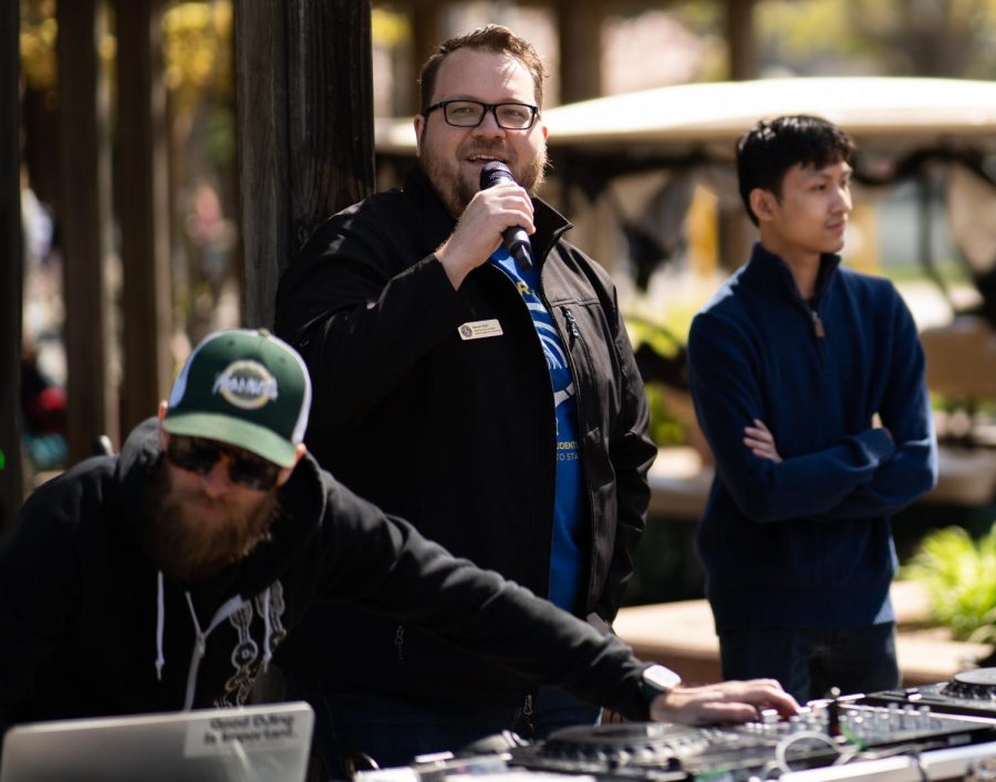 ASI Student Services Coordinator for KSSU Aaron Wall (middle) holding a microphone at an event in the Library Quad Monday, March 27, 2023. Wall is accused of making a Nazi salute during the recording of a podcast at KSSU.