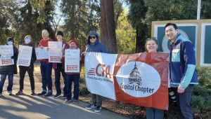 California Faculty Association members and supporters holding signs and banners at Sacramento State’s campus entrance Jan. 23, 2023. The union is preparing for its upcoming negotiations with the California State University system in May.