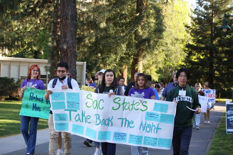 Students march together at the Take Back the Night event starting in the Library Quad at Sacramento State Wednesday, April 26, 2023. The event is put on annually to support survivors of sexual assault. 