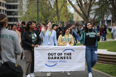 The Out of the Darkness Campus Walk commences through the pathways at Sacramento State Thursday, April 6, 2023. Staff from Student Health Counseling Services in The WELL and Vice President of University Affairs, Alexandra Estrella lead the group.