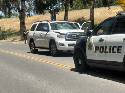 A white SUV with a shattered windshield on State University Drive near Sequoia Hall after colliding with a cyclist Saturday morning, May 27, 2023. A Sacramento State police officer said the victim was pronounced dead on the scene. 