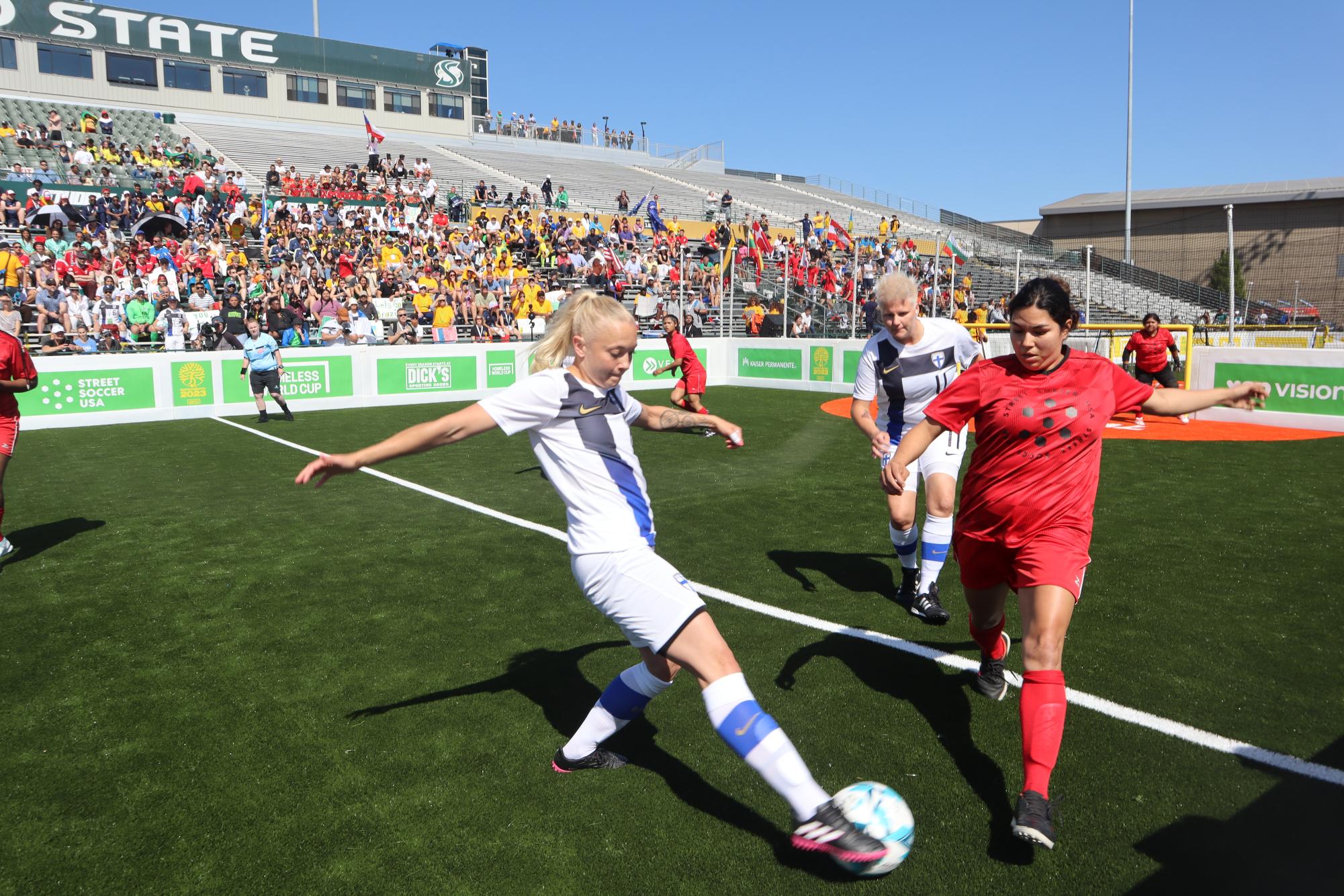 A USA women’s soccer player attempts to block Finland at the Homeless World Cup’s introductory street soccer match at Sacramento State’s Hornet Stadium July 8. Street Soccer USA brought the HWC to Sacramento from July 8 to July 15.