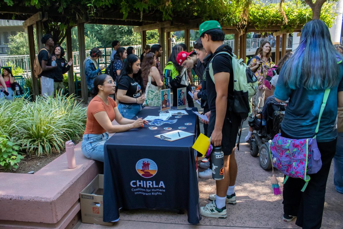 Students gather at the booth for the Coalition for Humane Immigrant Rights, Wednesday, Sept. 20, 2023. The booth worked to make students aware of local resources regarding citizenship, DACA, deportation and immigration legal services. 