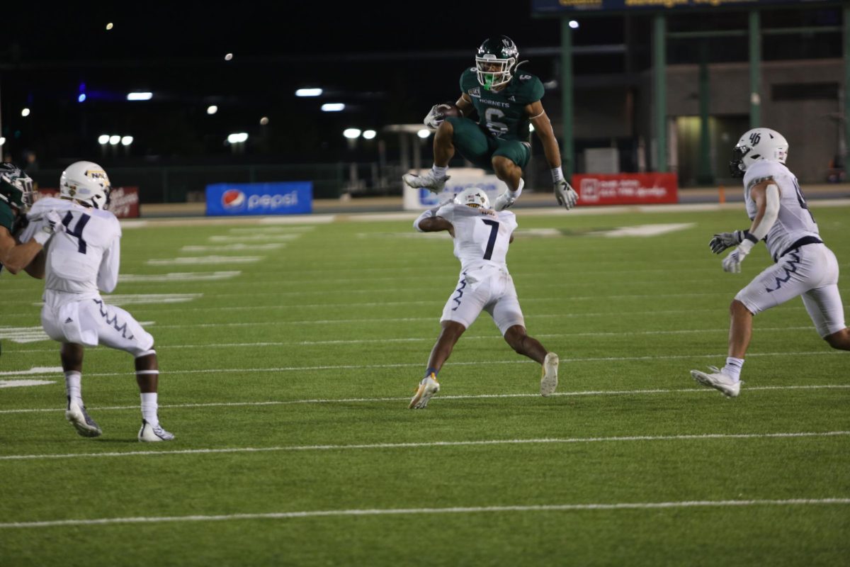 Sac State junior running back Ezra Moleni hurdles a Northern Arizona defender Sept. 30, 2023. Moleni was the Hornet’s lead running back because senior running back Marcus Fulcher is dealing with an ankle injury.
