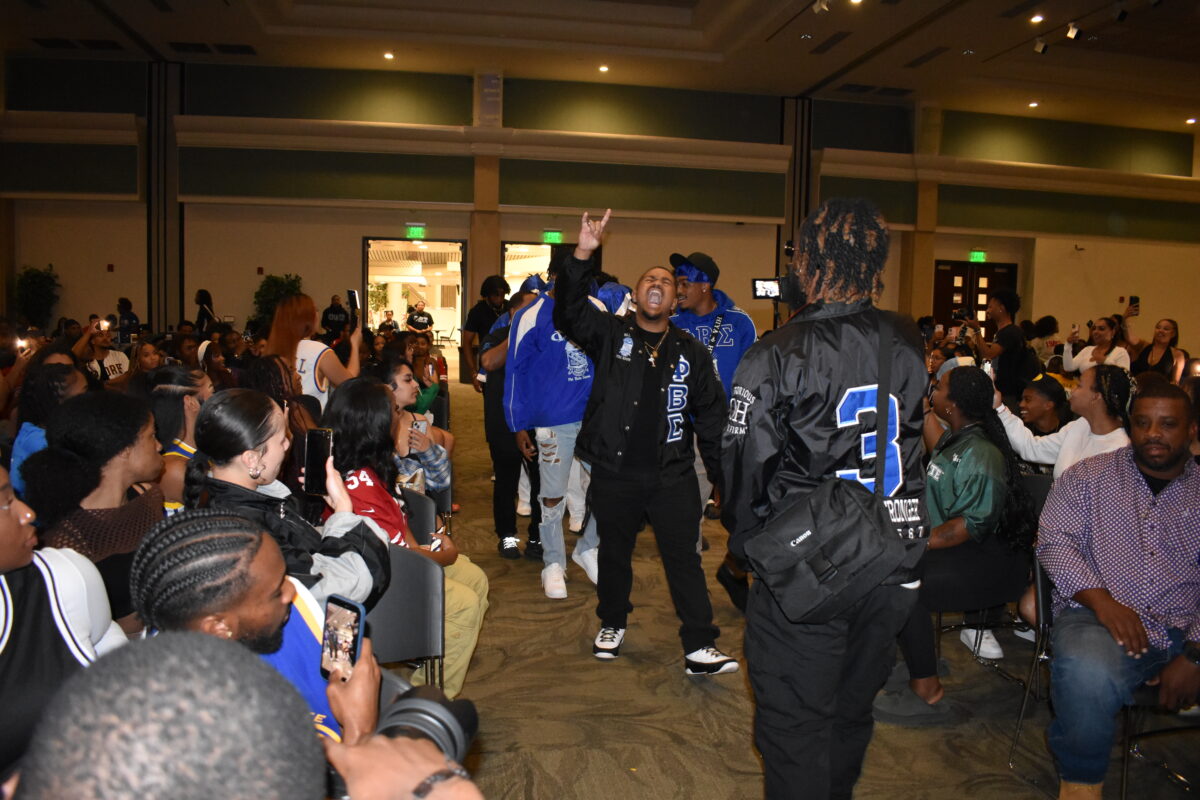 Alumnus Dennis Mundy leads Omicron Eta chapter of the Phi Beta Sigma fraternity to the stage for their performance at Black Org Night in the University Union Ballroom Friday, Sept. 22, 2023. Students in the crowd recording with their phones are shocked by Phi Beta Sigma’s energy.