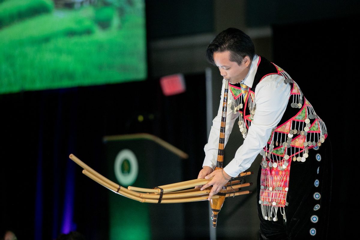 A performer at Sac State’s Hmong New Year celebration playing a Qeej on Monday, Nov. 14, 2022. A Qeej is a bamboo pipe instrument used in the Hmong culture, it is known to be played during funerals, weddings, rituals and more.  (Photo courtesy of Project HMONG)