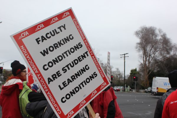 A sign held up by one of the Sac State picketers on Monday, Jan. 22, 2024. The CFA stated in an Instagram post that they have managed a tentative agreement with the CSU on equal pay and safer working conditions. 
