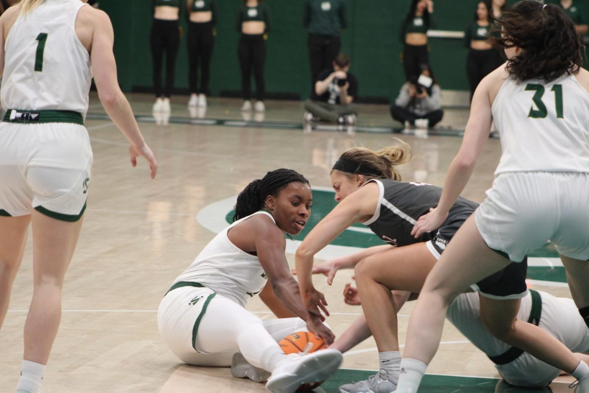 Senior forward Solape Amusan dives onto the floor to wrestle the ball away for possession against a Montana player. She finished the game with 8 points and 7 rebounds Thursday, Feb. 22, 2024, at The Nest.
