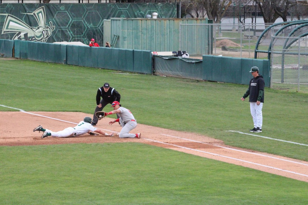Junior left fielder Matt Masciangelo diving back to first base on a pick-off as senior first baseman Brendan Bobo attempts to tag him Friday, Feb. 16, 2024. Masciangelo ended the series with 8 hit-by-pitches in 13 plate appearances.