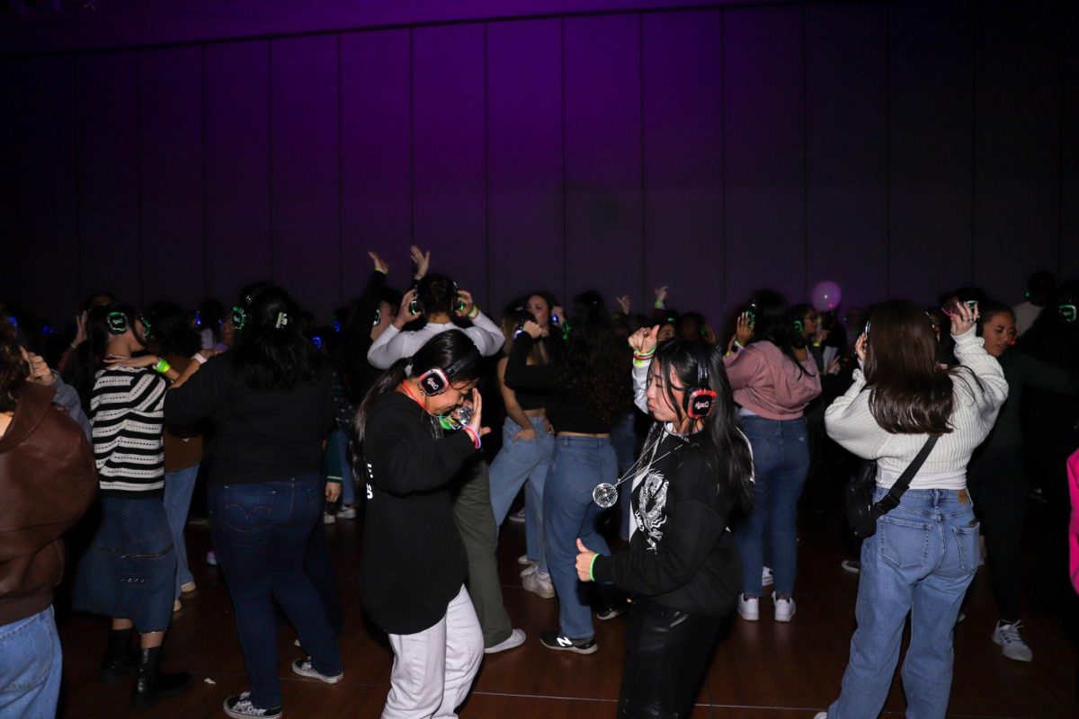 A glimpse of the dance floor while students enjoy music provided by the DJs on stage in the University Union Ballroom at the Silent Disco event Thursday, Feb. 1, 2024. Songs ranging in genres from pop classics to dubstep played throughout the night. 