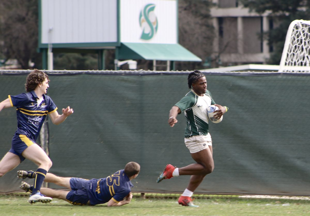Sophomore flanker Kenneth Kimbrough runs down the left sideline of the Sac State Intramural Field avoiding defenders for the first try of the Sac State men’s rugby club game Saturday, Feb. 3, 2024. Kimbrough finished with one try along with multiple tackles throughout the first and second half against University of California, Santa Cruz. 