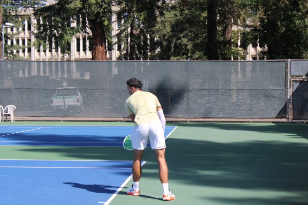 Senior mens tennis player Mark Keki gets ready for another serve Friday, March 8, 2024 at the Sacramento State tennis courts. Keki won the first set in his singles match, with the match ending unfinished.