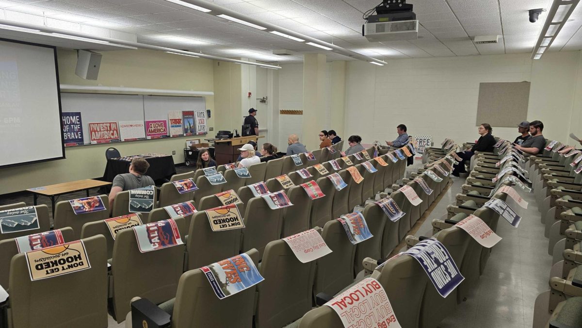 Sac State students and visitors from off campus wait for Paula Scanlan to begin her discussion for Turning Point USA Tuesday, April 2, 2024. Signage posted around the room included anti-trans rhetoric, appeals to patriotism and reminders about the importance of gun ownership.