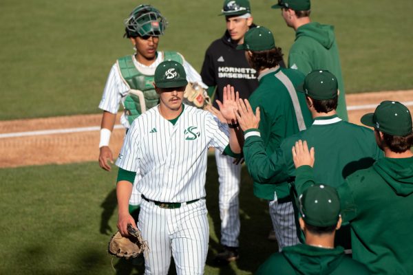  Redshirt senior pitcher Evan Gibbons and sophomore catcher Jacob Cortez celebrating with the team after getting the final strikeout of the inning while walking into the dugout against California Baptist University on Friday, April 5, 2024. Gibbons has a total of 40 strikeouts currently this season. 