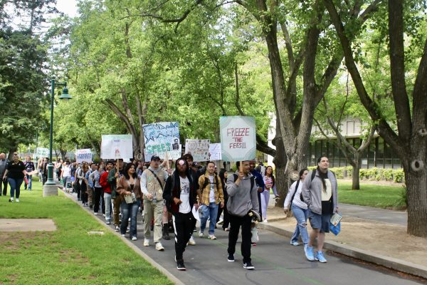 Students of the sociology 136 class march around campus and the Library Quad at a protest for the new CSU system tuition fees Wednesday, April 24, 2024. The rally and march included chants such as “freeze the fees.”