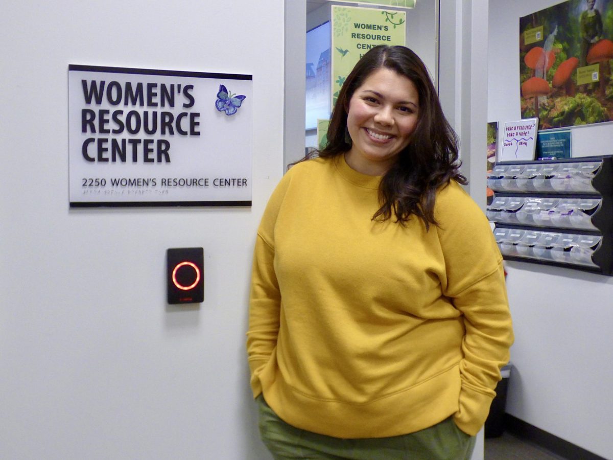 Women’s Resource Center program coordinator Stephanie Alcala stands outside the entrance to the center’s room Wednesday, March 27, 2024. Alcala is a student at Sacramento State, mother and has been working at the resource center for just under a year. 