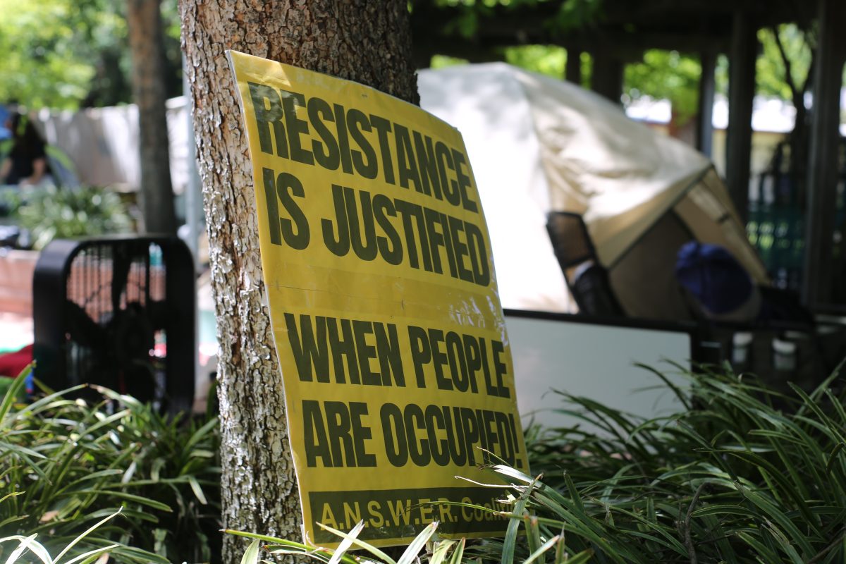 One of the many signs decorating the pro-Palestine encampment site in the Library Quad Tuesday, April 30, 2024. Signs at the protest said phrases such as “Bread not Bombs” and “Resistance is justified when people are occupied.”