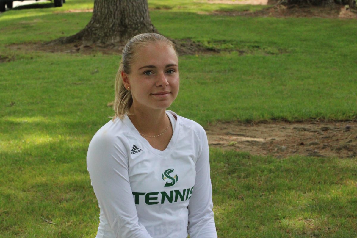 Redshirt freshman Lou Baudouin sitting on a bench outside Yosemite Hall Tuesday, April 16, 2024. Baudouin earned All-Big Sky Conference honors in both singles and doubles in her first full season.