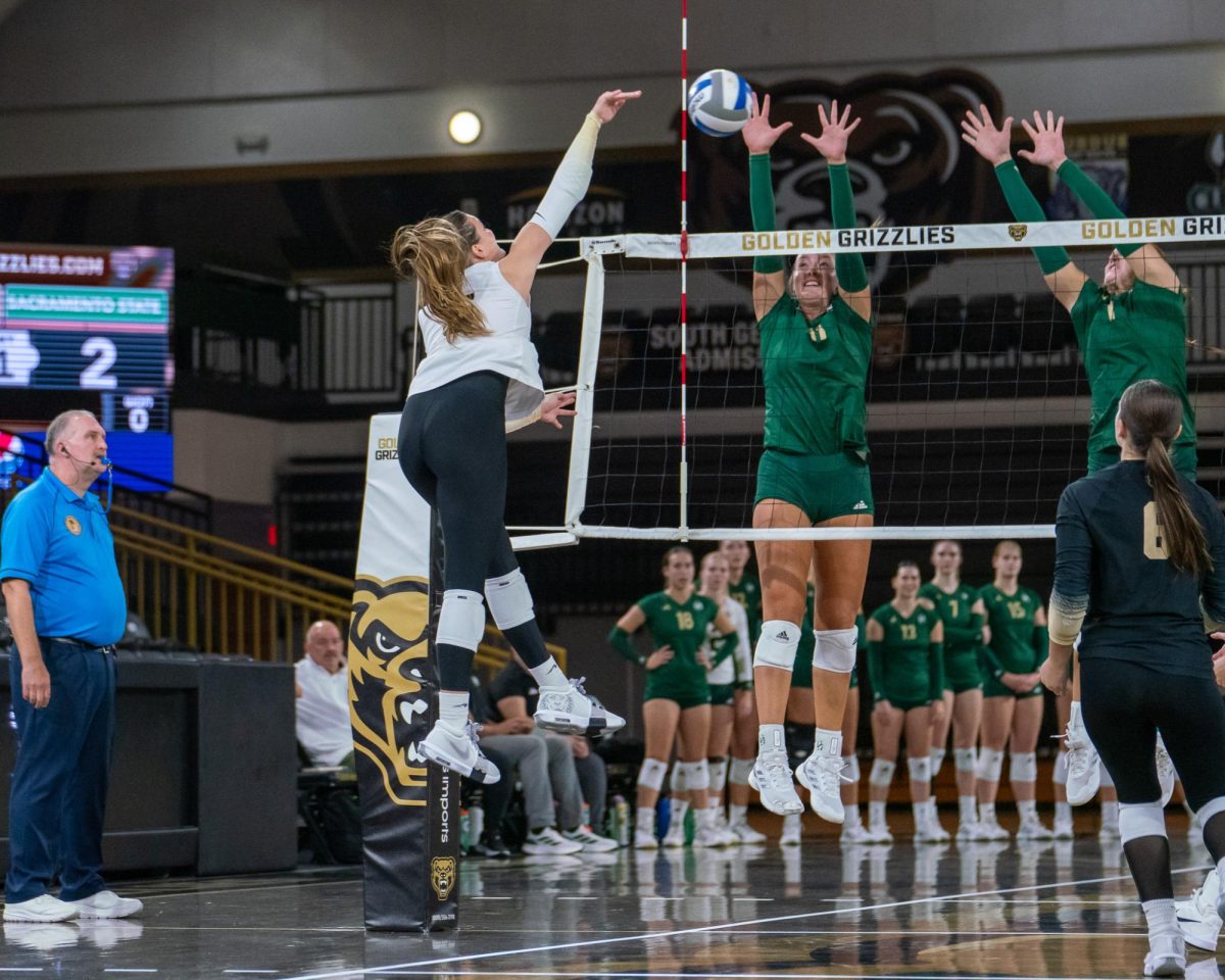 Senior outside hitter Ellie Tisko and sophomore middle blocker Karlie Spohn go up to block the potential kill by Oakland Friday, Sept. 13, 2024. The Hornets won the match 3-0. 