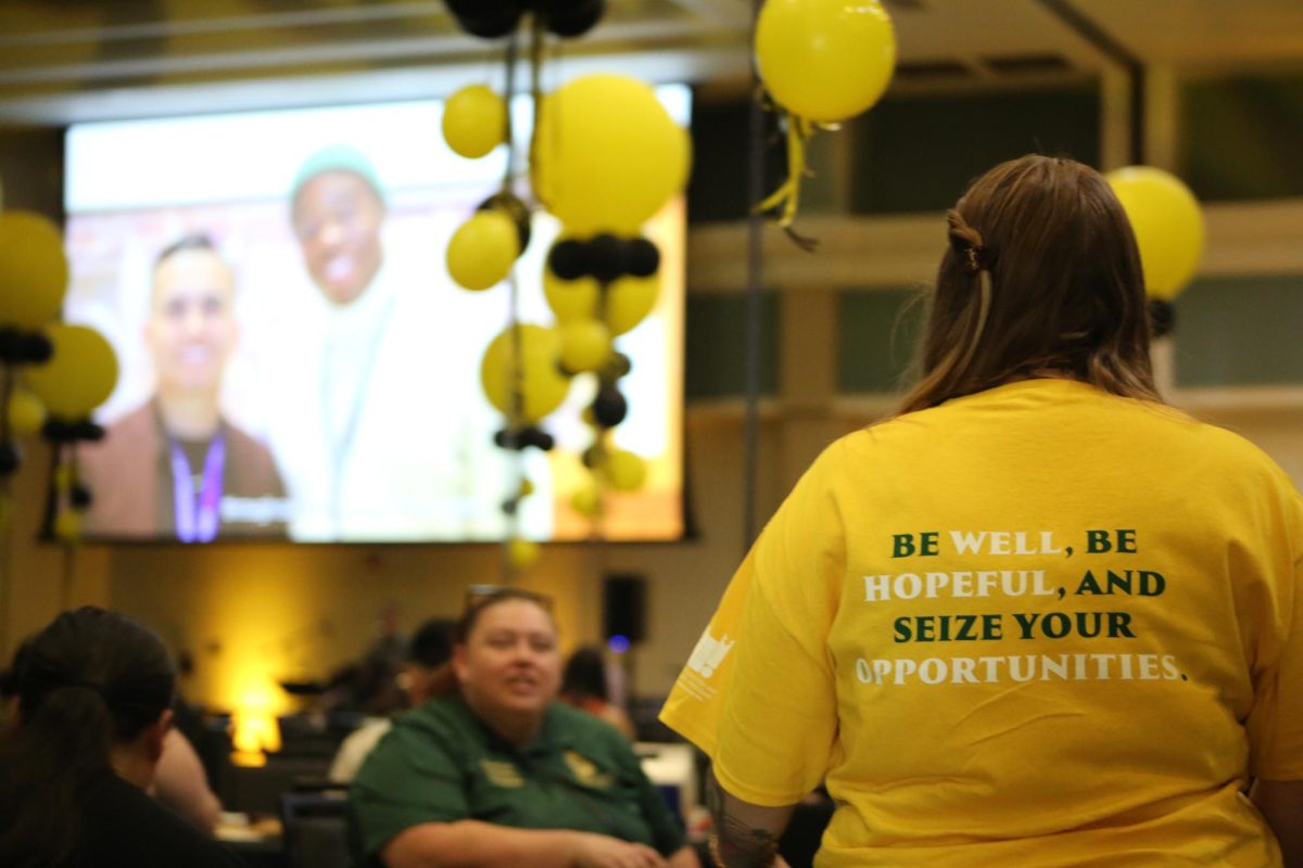 A student volunteer watches a presentation made by the Student Academic Success & Educational Equity Programs commemorating Student Academic Success day in the University Ballroom Sept. 30, 2024. The Hope Luncheon featured a fireside chat and a keynote speaker, for students to hear stories of healing and empowerment.