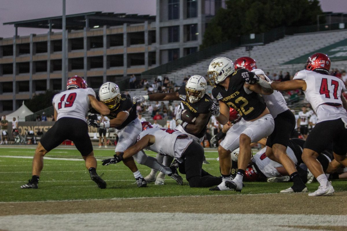 Sacramento State junior running back Elijah Tau-Tolliver powering through Eastern Washington defenders Saturday, Oct. 12, 2024. Tau-Tolliver ended the game with 94 rushing yards in the 35-28 loss. 