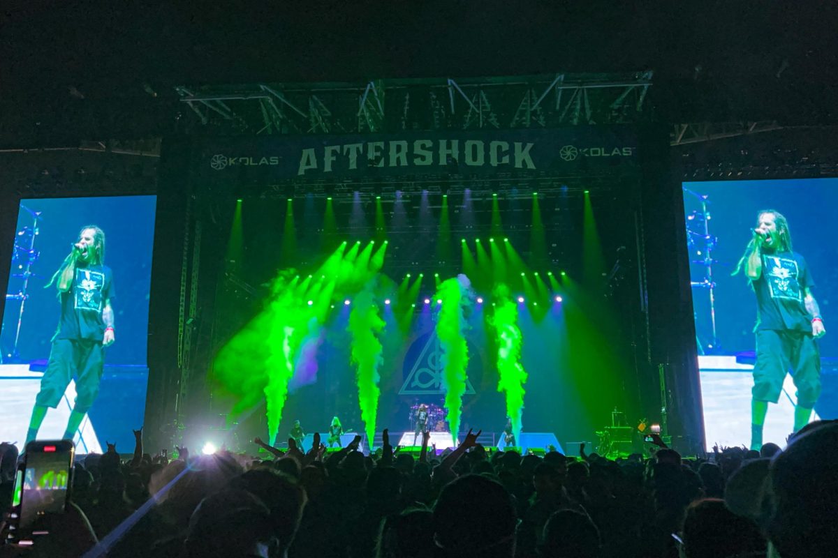 Lamb of God performs at Aftershock Festival with special effects of smoke and ominous lighting in Discovery Park on Friday, Oct. 7, 2022. A cast of green fills the stage around lead singer Randy Blythe while performing “Memento Mori” from the band’s 2020 album.