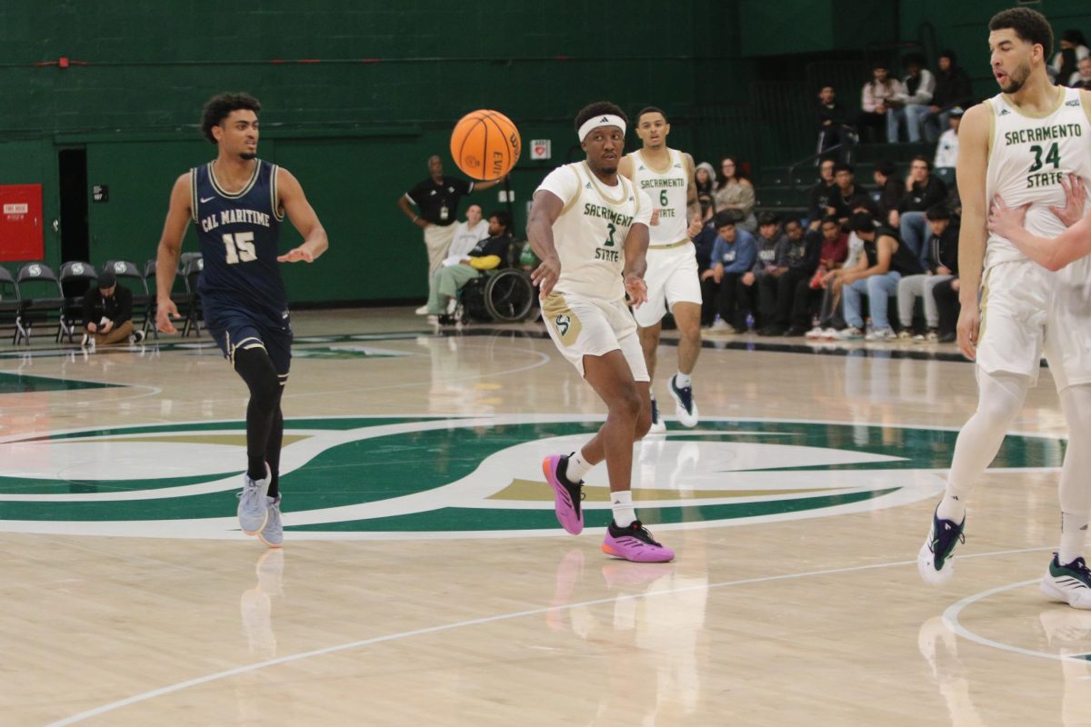 Senior guard EJ Neal passing to a teammate Tuesday, Nov. 5, 2024 in Sacramento State’s win over Cal Maritime. Neal finished with five assists.