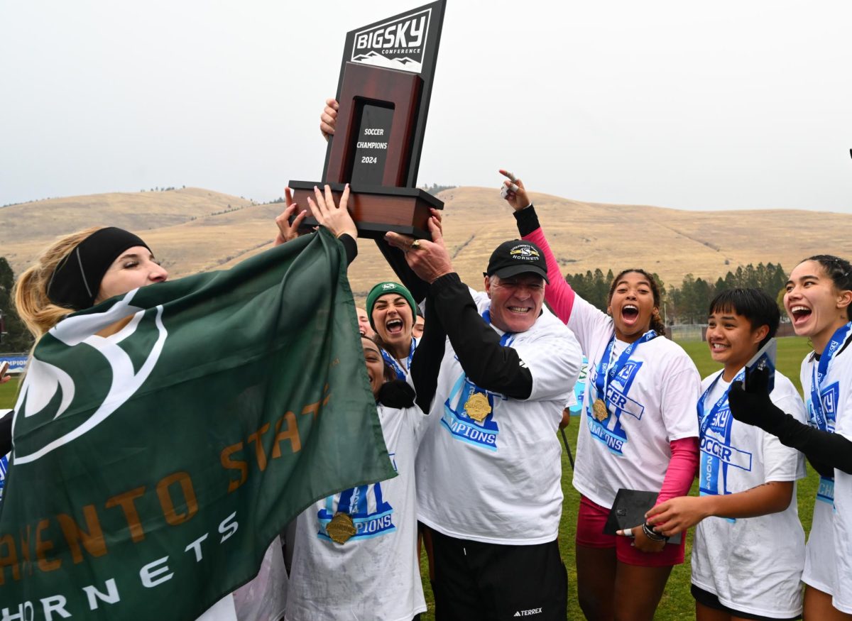 Sacramento State head coach Randy Dedini holding up the Big Sky Conference Trophy after defeating Idaho in the championship game Sunday, Nov. 10, 2024. The Hornets beat the Vandals in penalty kicks, 7-6.