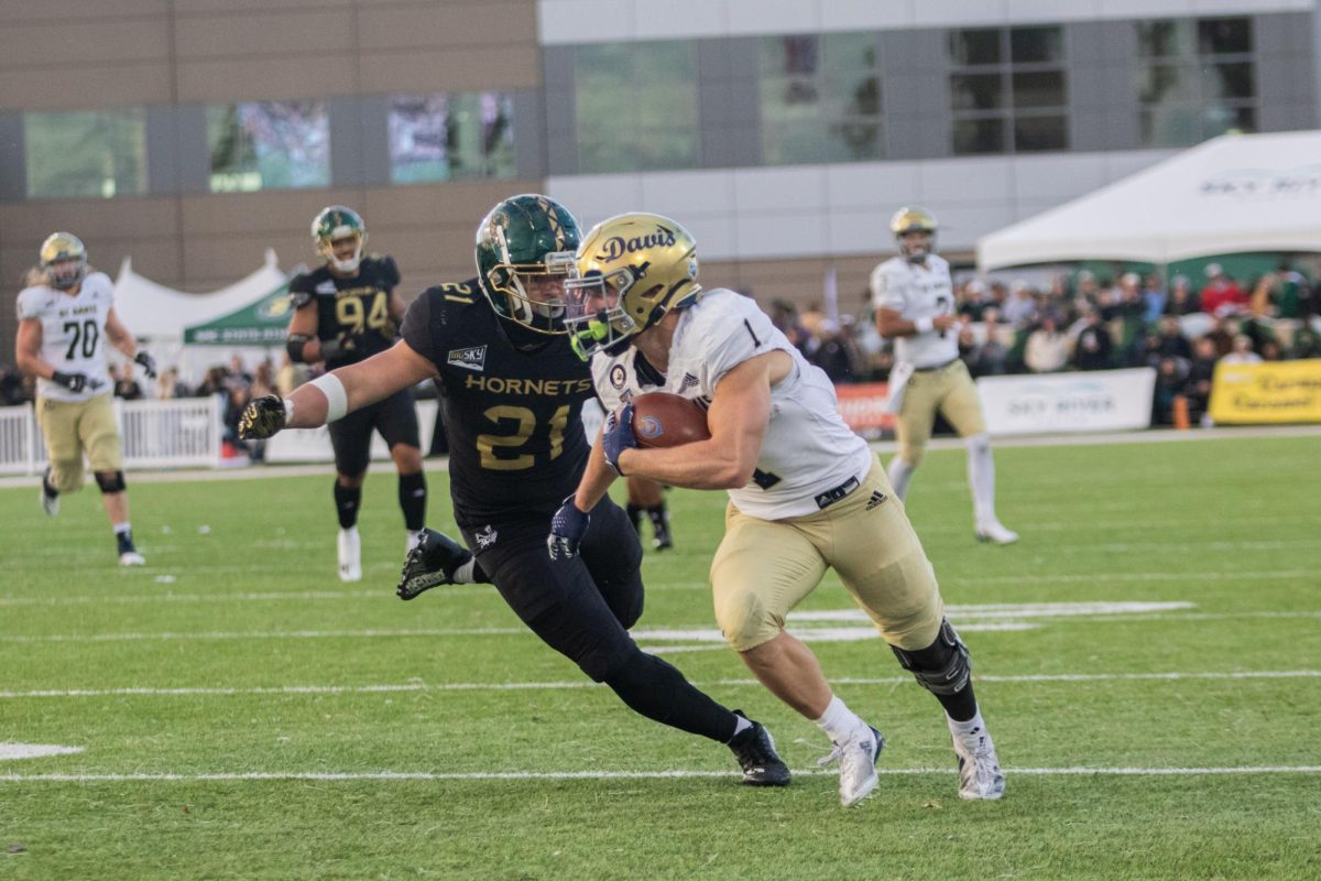 UC Davis senior wide receiver CJ Hutton catches a pass and turns upfield in the Causeway Classic Saturday, Nov. 23, 2024. Hutton had four catches for 75 yards.