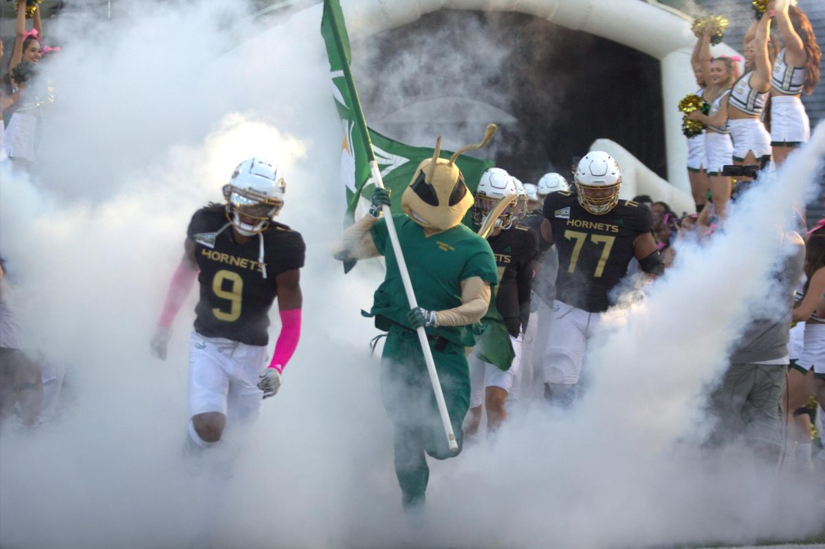 Herky the Hornet and the Sac State football team runs out onto the field before their match against Eastern Washington Saturday, Oct. 12, 2024. That game was the first conference game played at home for the Hornets.