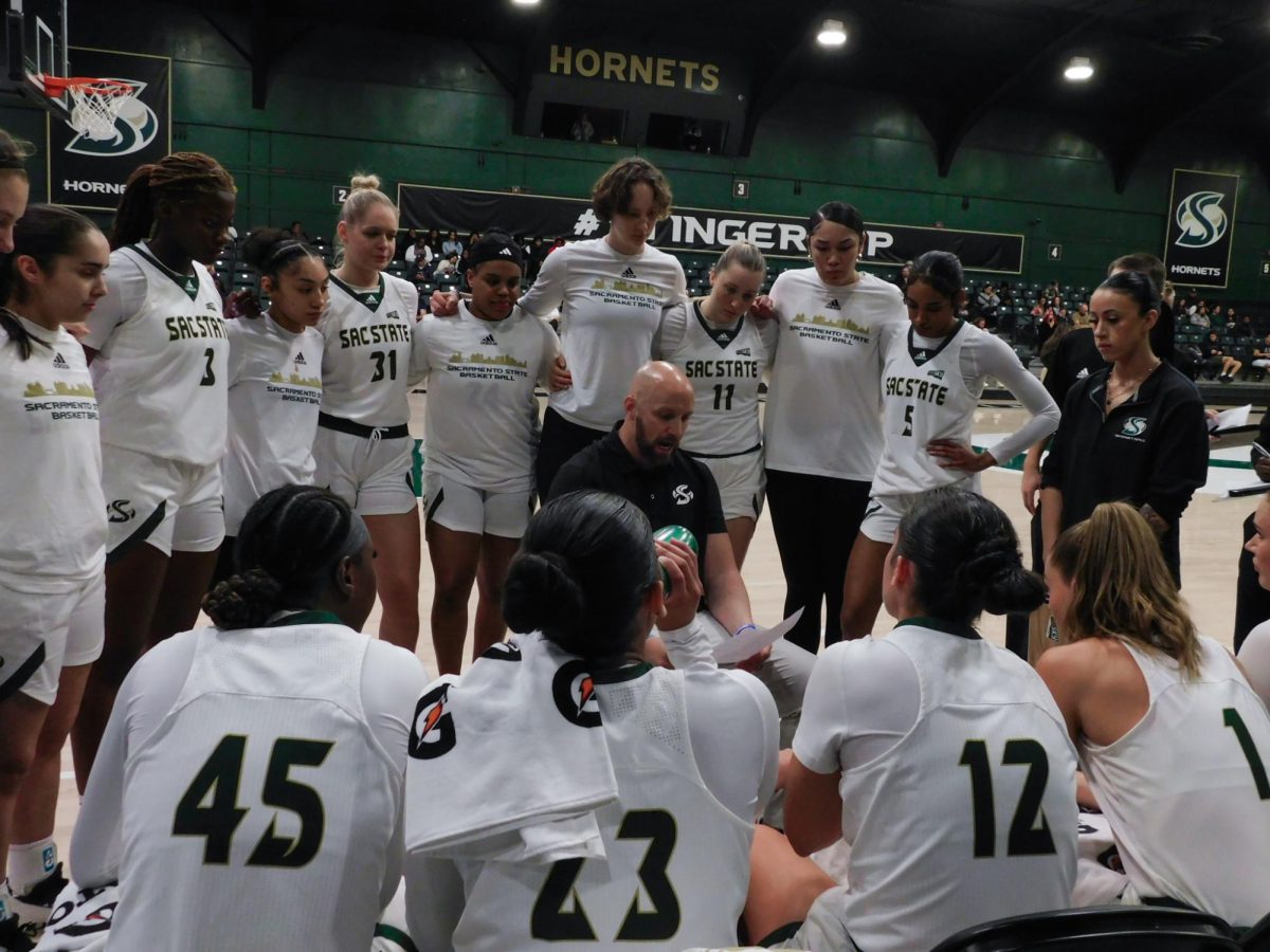 Sacramento State huddles around head coach Aaron Kallhoff during a timeout against Long Beach State Sunday, Nov. 17, 2024. The Hornets lead the Big Sky Conference with a 4-1 record.