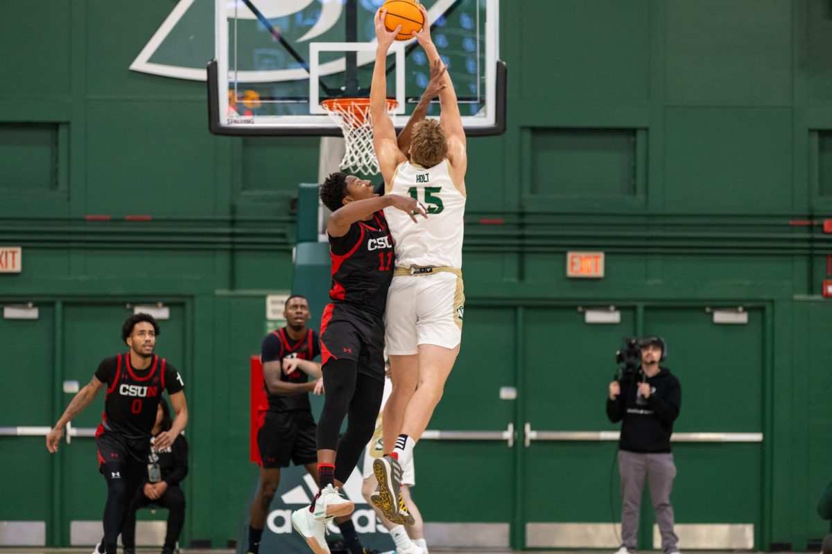 Senior forward Jacob Holt goes up for a dunk attempt over a CSUN Matador defender Saturday, Nov. 16, 2024. Holt hit a career-high of 20 points in a game.