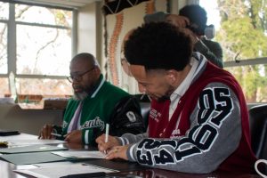 Sacramento State President Luke Wood signs the memorandum with Compton College President and CEO Keith Curry in Sacramento Hall Thursday, Dec. 12, 2024. The memorandum is a stepping stone to future programs and establishes a pipeline between CC and Sac State for transfer students.