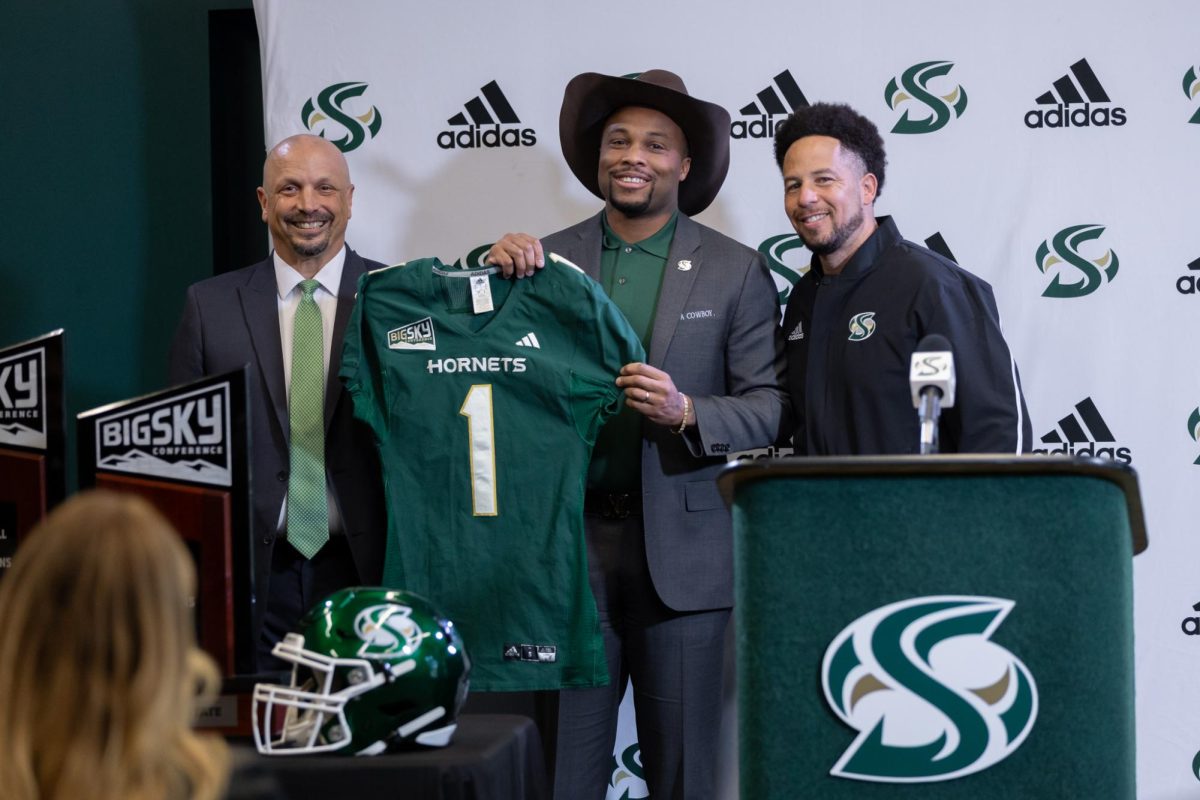 (L-R) Athletic Director Mark Orr, incoming head coach Brennan Marion and President Luke Wood hold up a Sacramento State jersey Wednesday, Jan. 8, 2025. Marion said the support he’s received from Wood and Orr played an important role in him choosing Sac State.