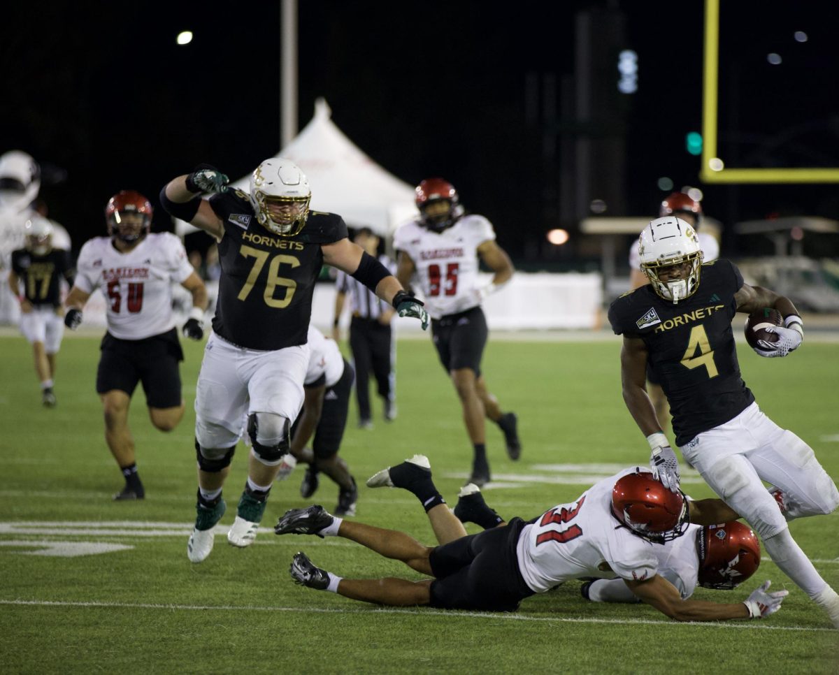 Former Sacramento State guard Jackson Slater throws a block for former Sac State running back Elijah Tau-Tolliver against Eastern Washington Saturday, Oct. 13, 2024. Slater said a well placed block is one of his favorite plays to watch on film.